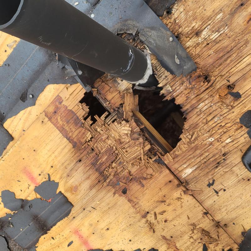 Roof decking damage around vent pipe with wood rot