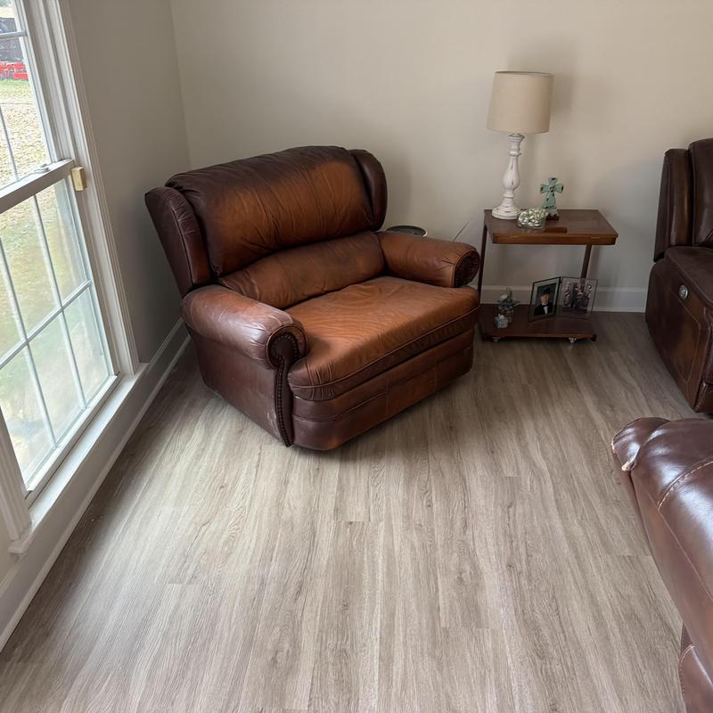 Vinyl plank flooring installation in living room corner Vinyl plank flooring installation in living room corner