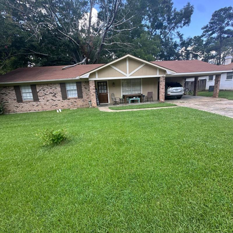 Asphalt shingle roof with large front yard and driveway