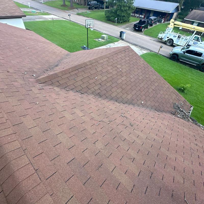 Asphalt shingle roof with debris during inspection