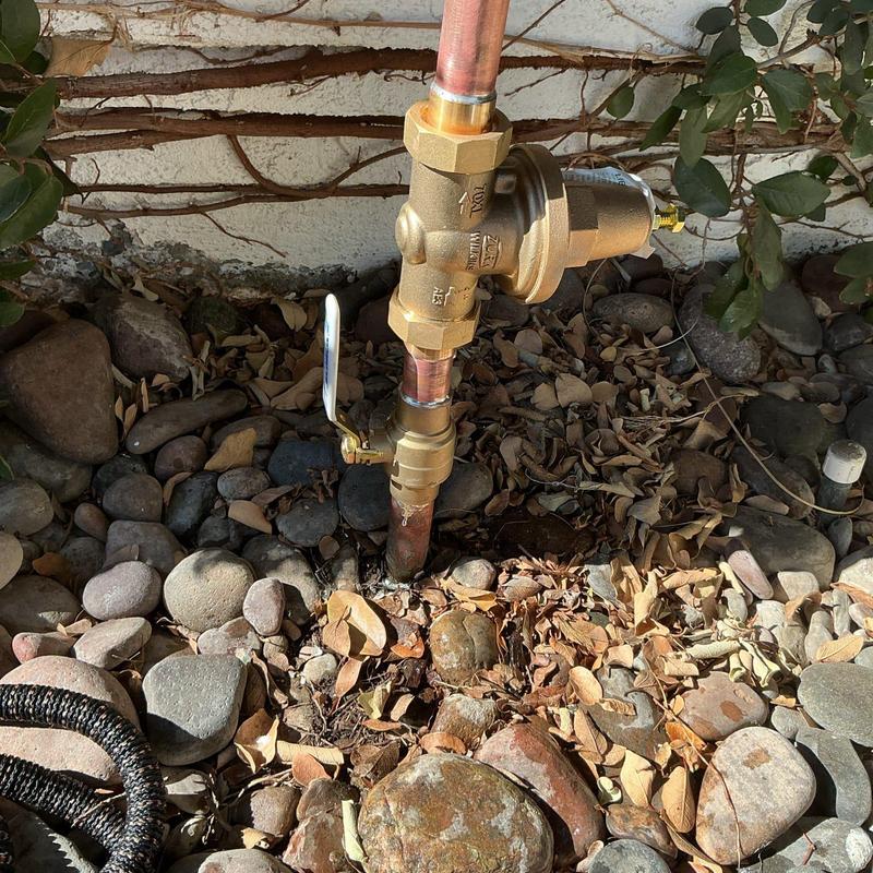 Pressure regulator on outdoor gas line with valve