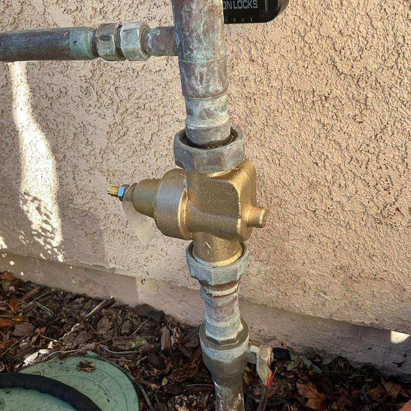 Pressure regulator valve on outdoor plumbing system