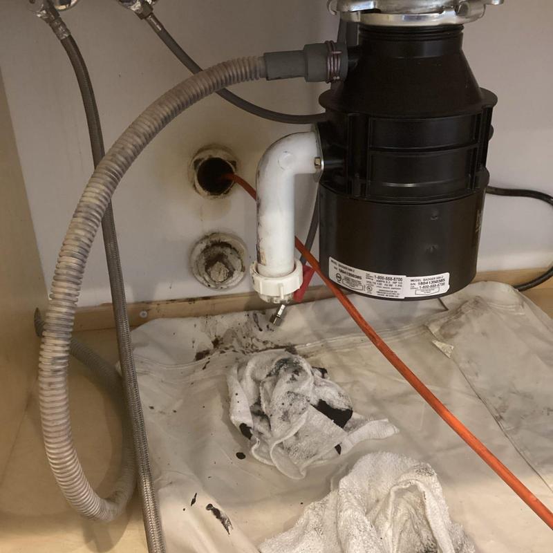 Kitchen sink drain pipe with cable snaking service underway