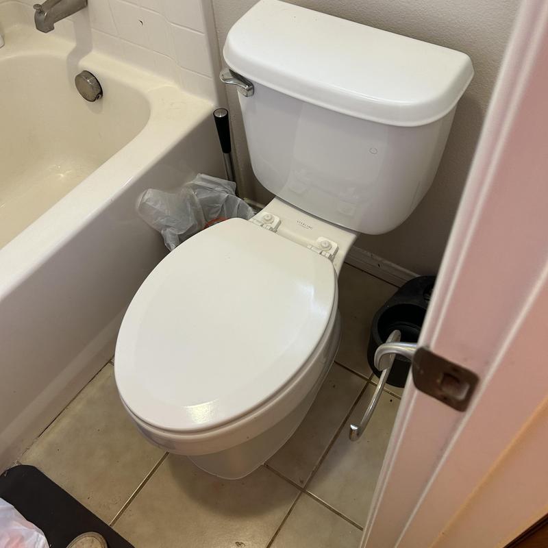 Toilet installation and drain snaking in bathroom corner