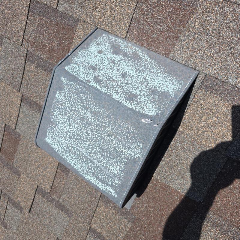 Roof vent with hail damage and surface wear