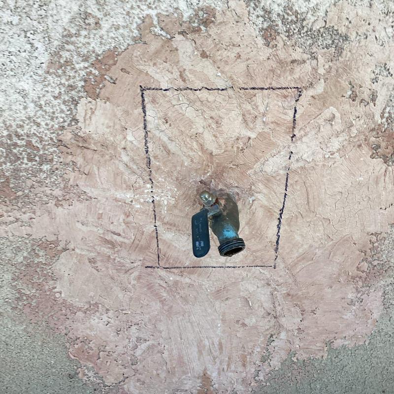 Leaking outdoor hose bib with marked stucco cutout