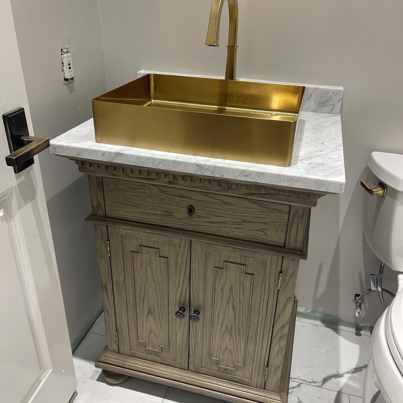 Vessel sink with faucet on marble vanity countertop