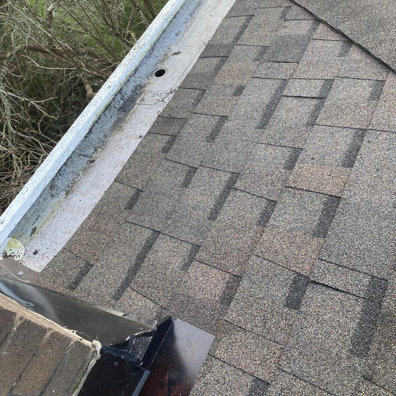 Asphalt shingle roof with metal flashing and gutter system