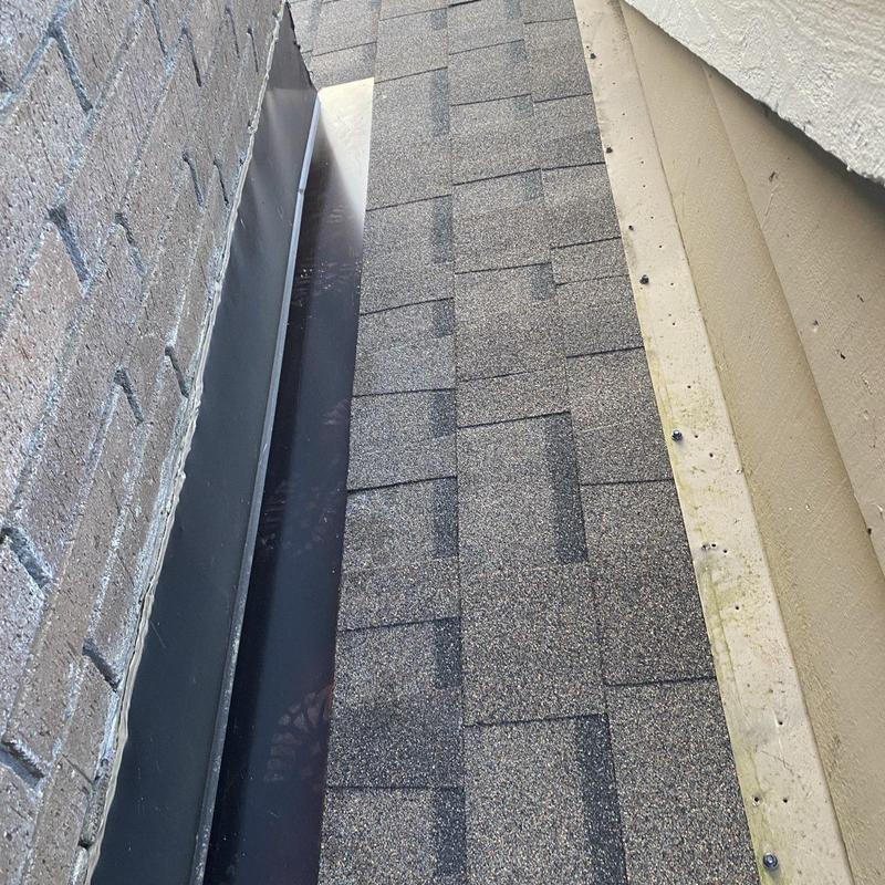 Roof shingles and metal flashing on roof edge