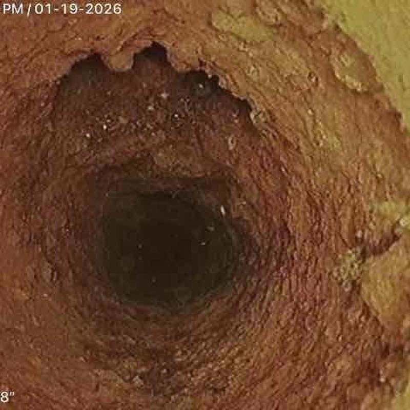 Cast iron sewer pipe with heavy rust buildup inside