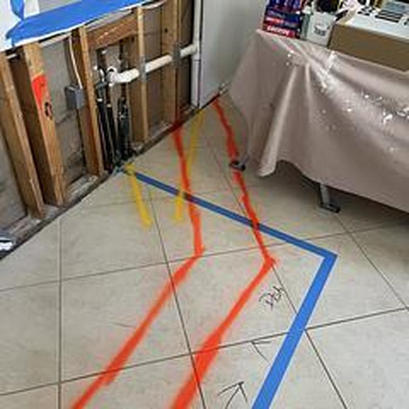 Kitchen drain lines marked for floor cutting