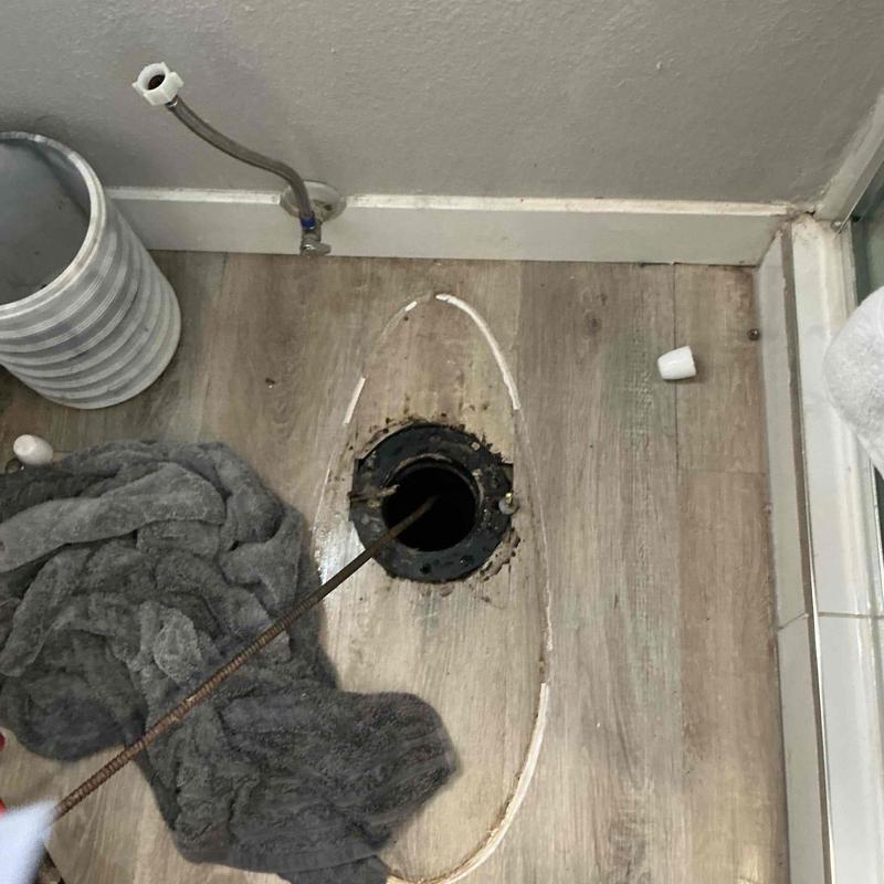 Toilet flange and drain line snaking in bathroom floor