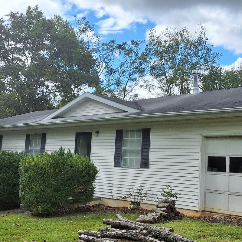 Asphalt shingle roof on white single-story house