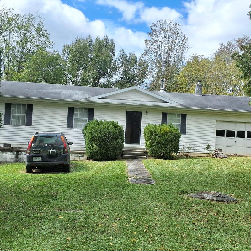 Asphalt roof with aging and discoloration on house
