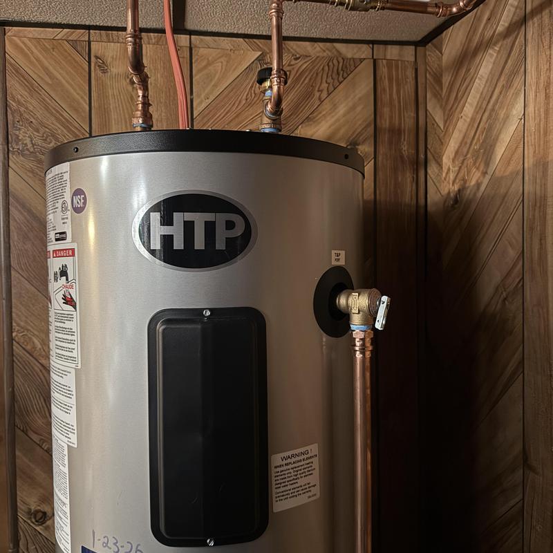 Water heater with copper piping installation in wooden room