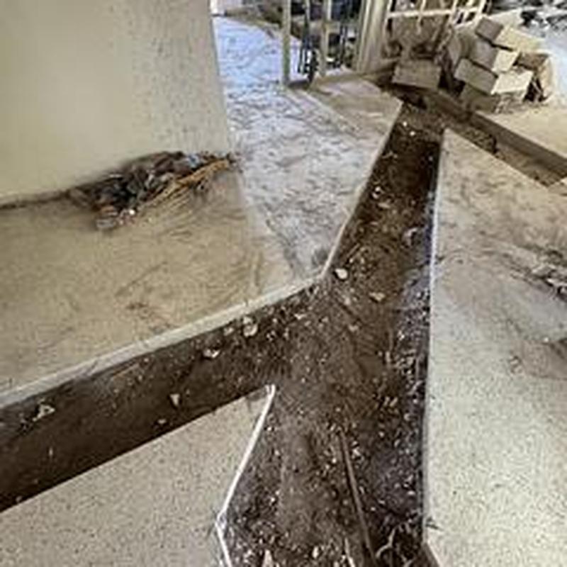 Cast iron drain removal trench cut in concrete floor