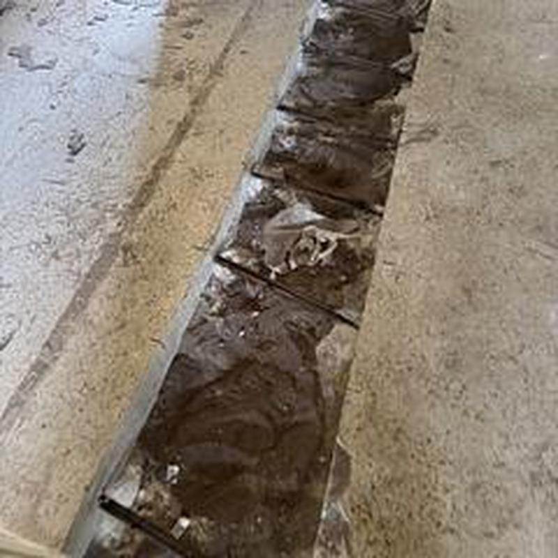 Cast iron drain trench cut into concrete floor