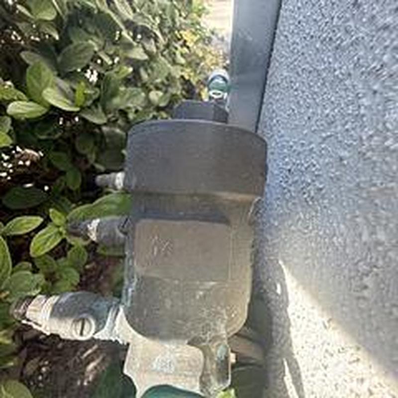 Backflow device with pressure gauges on exterior wall