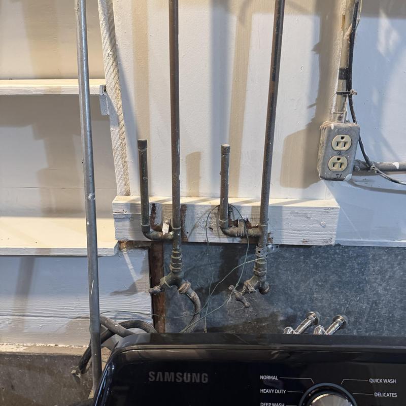 Laundry box with hot and cold water valves above washer