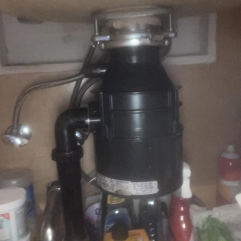Garbage disposal unit and kitchen sink drain under cabinet
