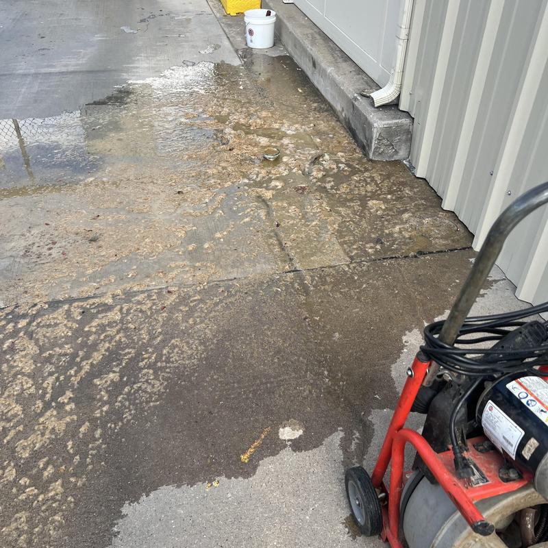 Main sewer line cleanout with water and debris spill