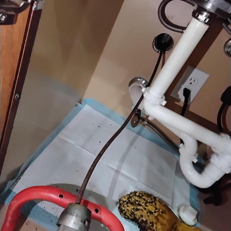 Kitchen sink drain cable clearing under sink