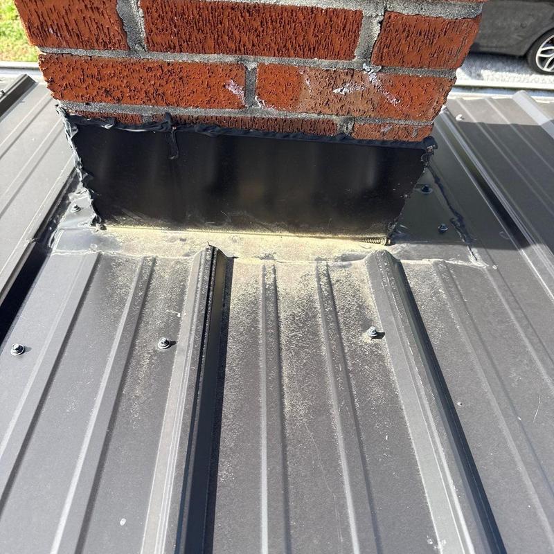 Metal roof chimney flashing with sealant and screws