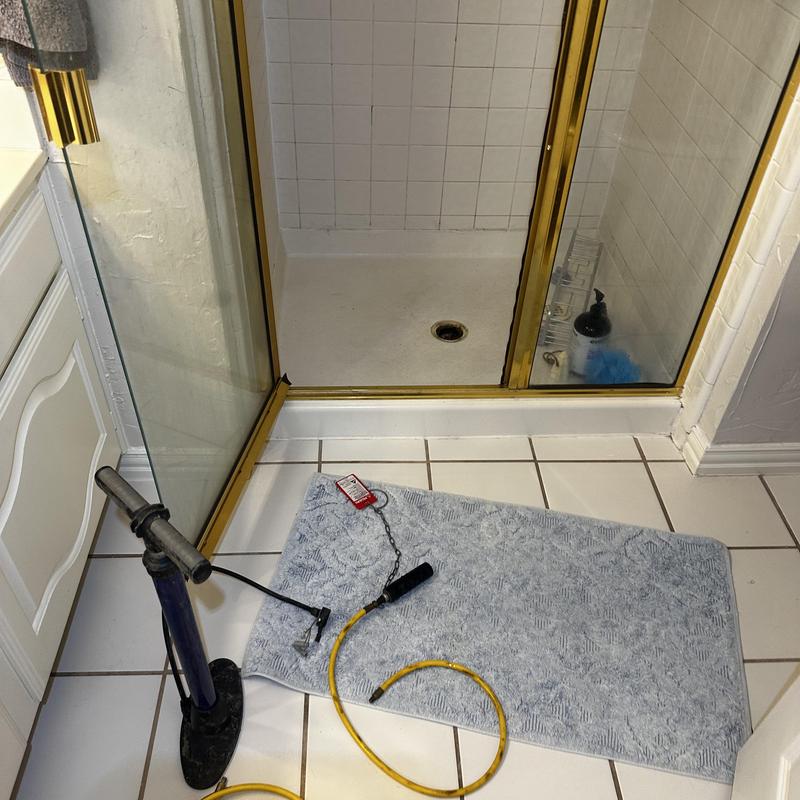 Shower pan drain with test equipment in bathroom