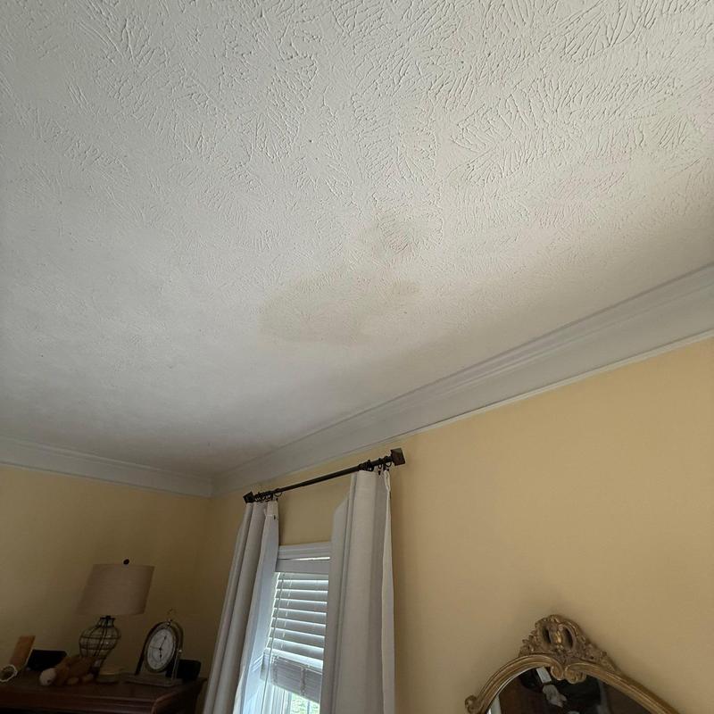 Ceiling water stain near window and curtains