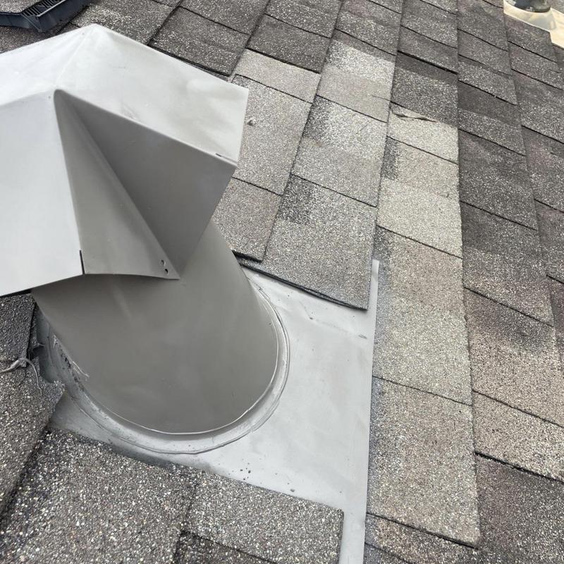 Exhaust vent pipe flashing on asphalt shingle roof