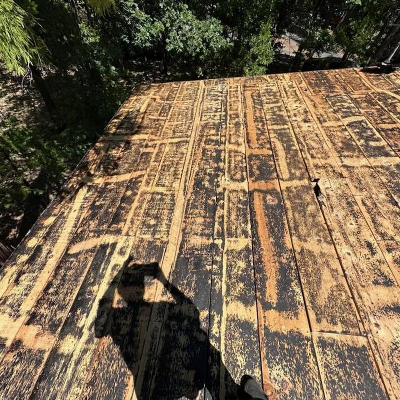 Roof deck with old shingle adhesive residue and damage