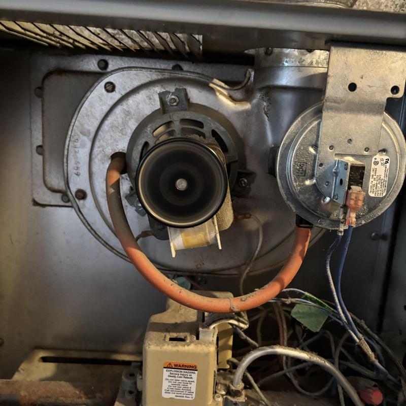 Draft inducer motor on Heil gas furnace interior near wiring Draft inducer motor on Heil gas furnace interior near wiring