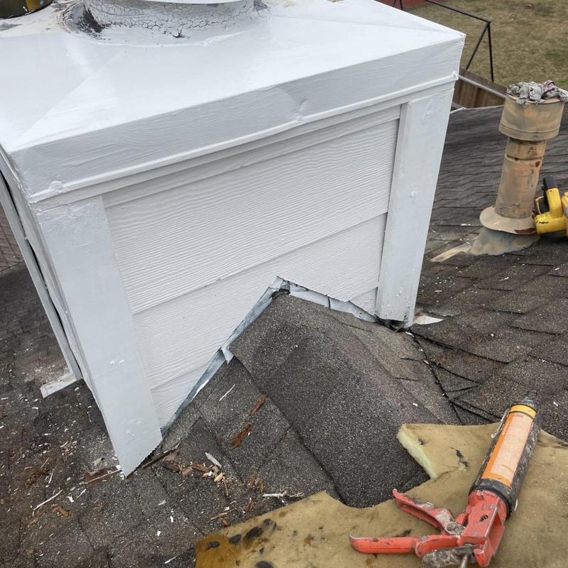 Chimney siding and roof flashing repair tools on roof