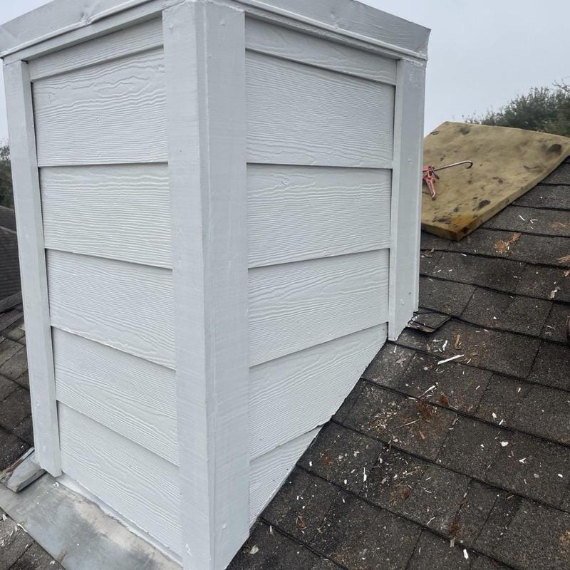 Chimney siding and flashing on asphalt roof
