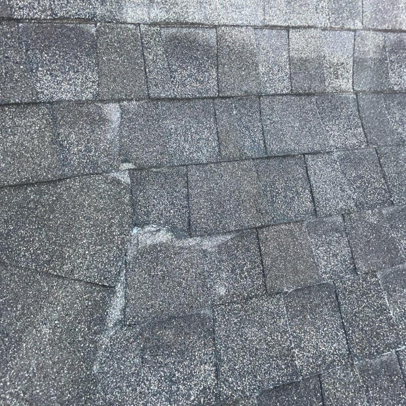 Architectural asphalt shingles with damage and wear
