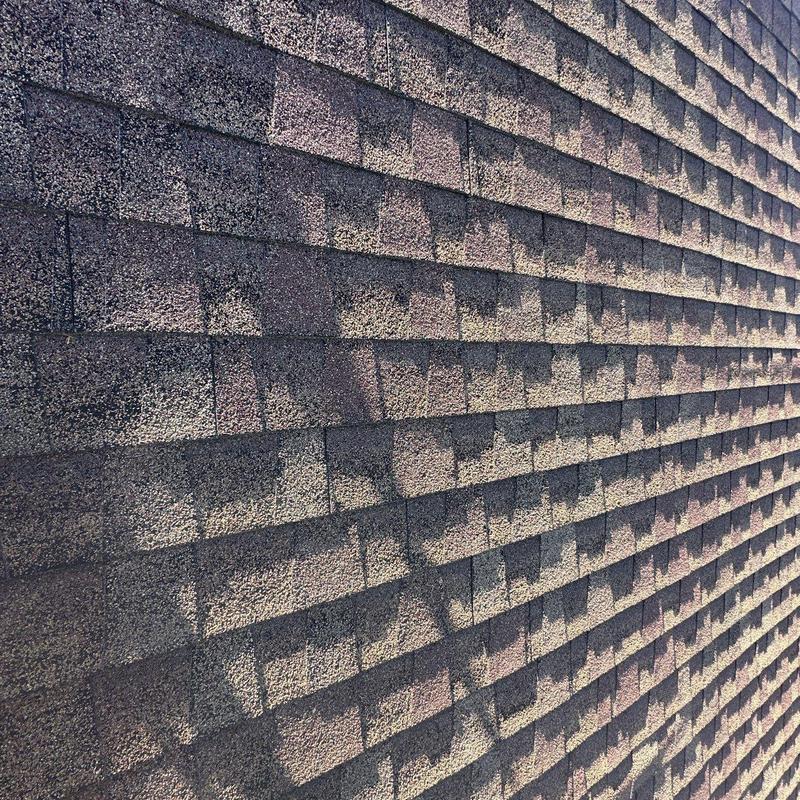 Asphalt shingle roof with hail damage and shadow pattern