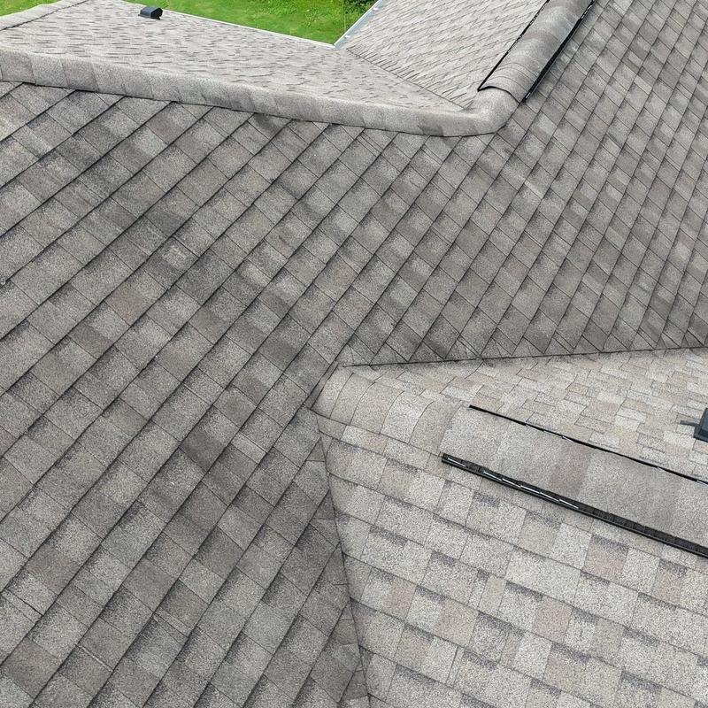 Asphalt shingle roof with hail damage and flashing seals