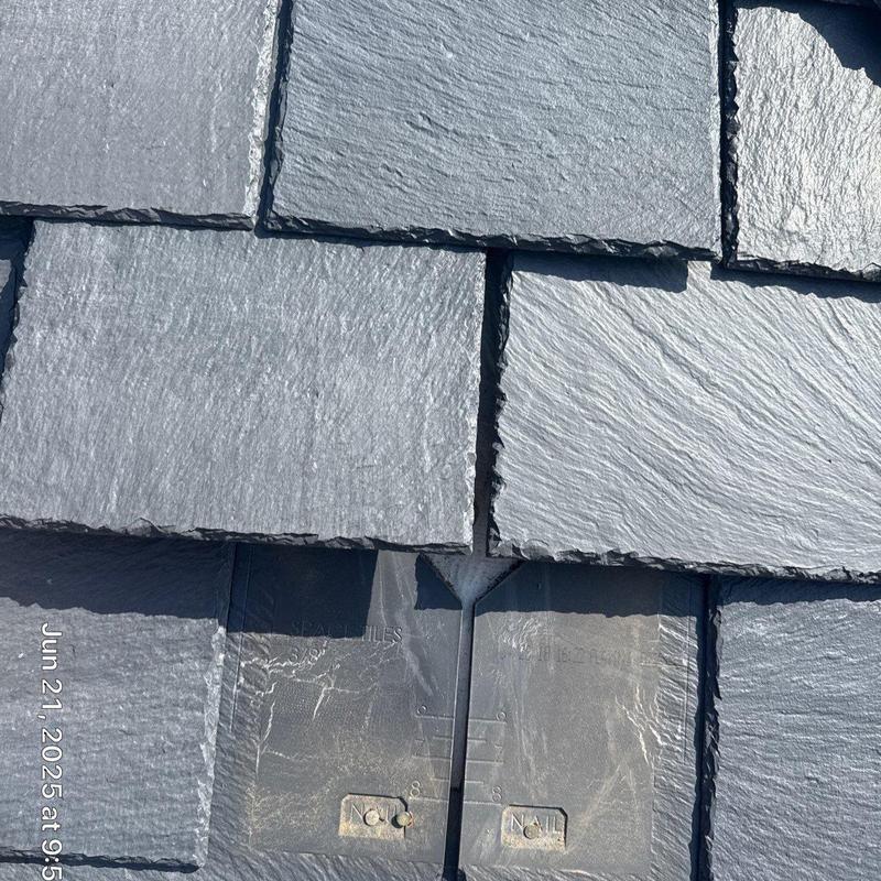 Slate roof shingles with hail damage inspection