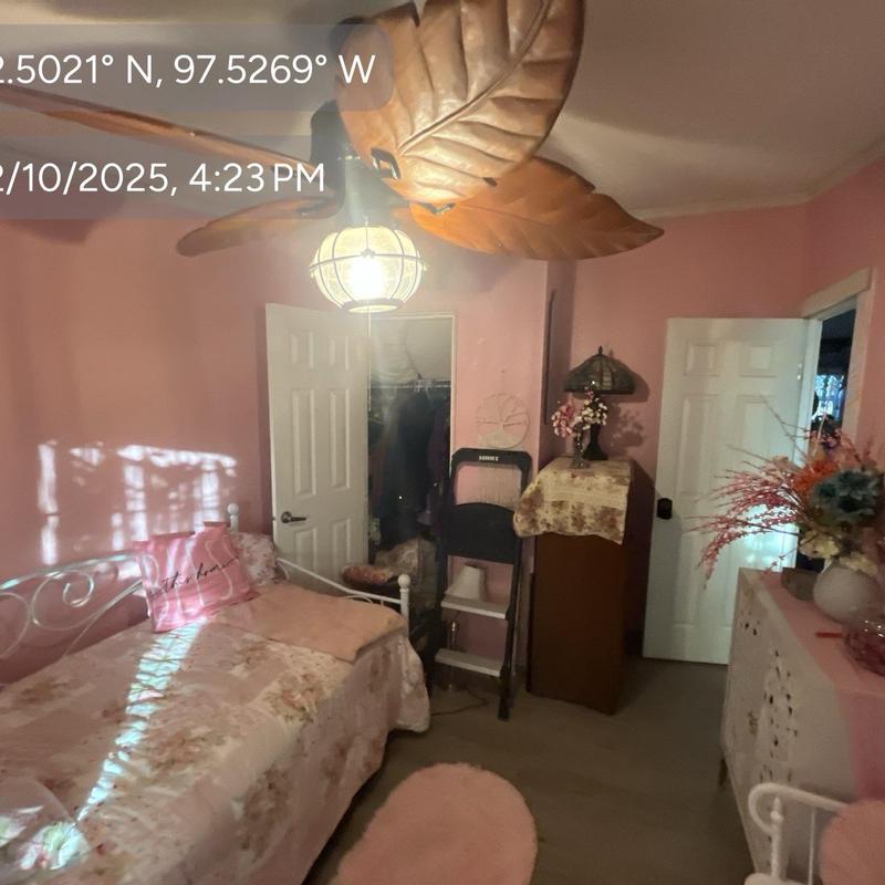 Ceiling fan with light fixture in pink bedroom
