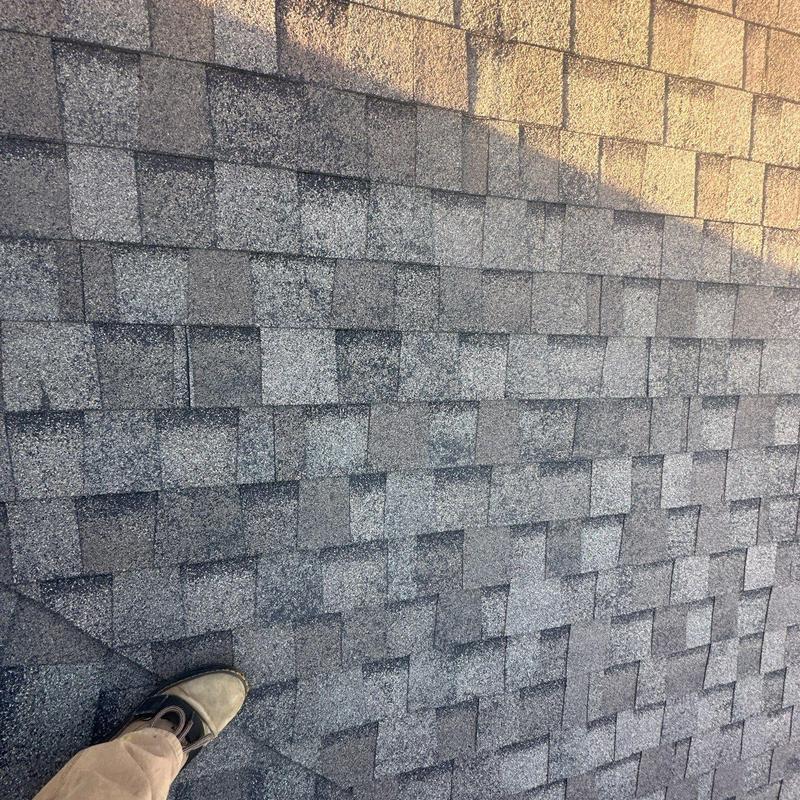 Asphalt shingles with hail damage and wear signs