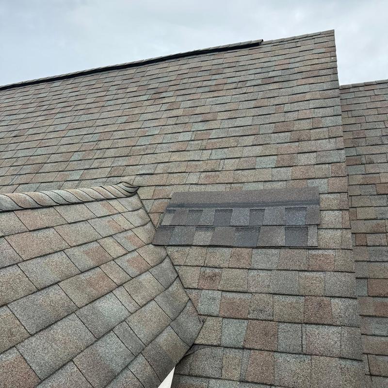 Asphalt shingle roof with hail damage and ridge components