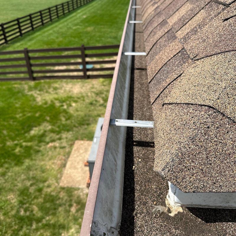 Asphalt shingle roof and gutter inspection with mounting brackets