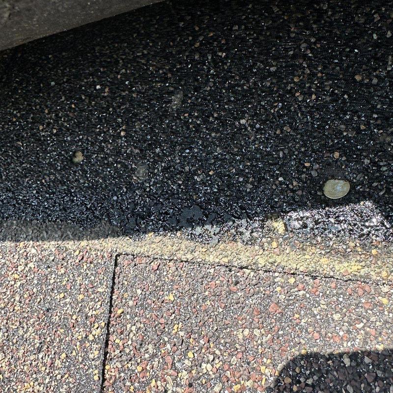 Asphalt shingle roof with hail damage and nails