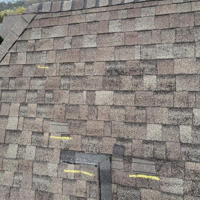 Shingle roof with hail damage and yellow markings