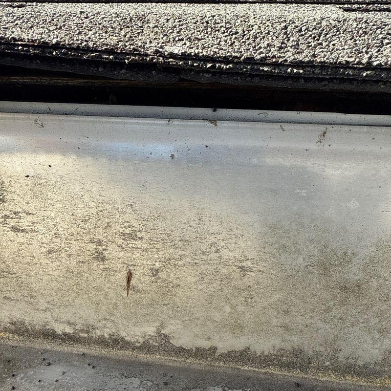 Roof flashing with grime and debris buildup close-up