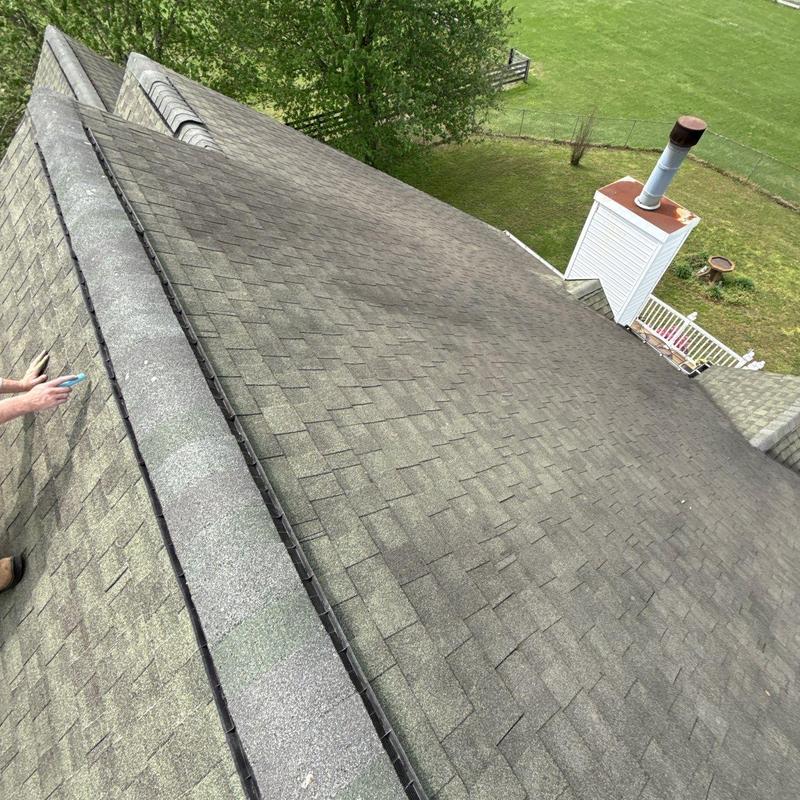 Asphalt shingle roof inspection with hail damage signs