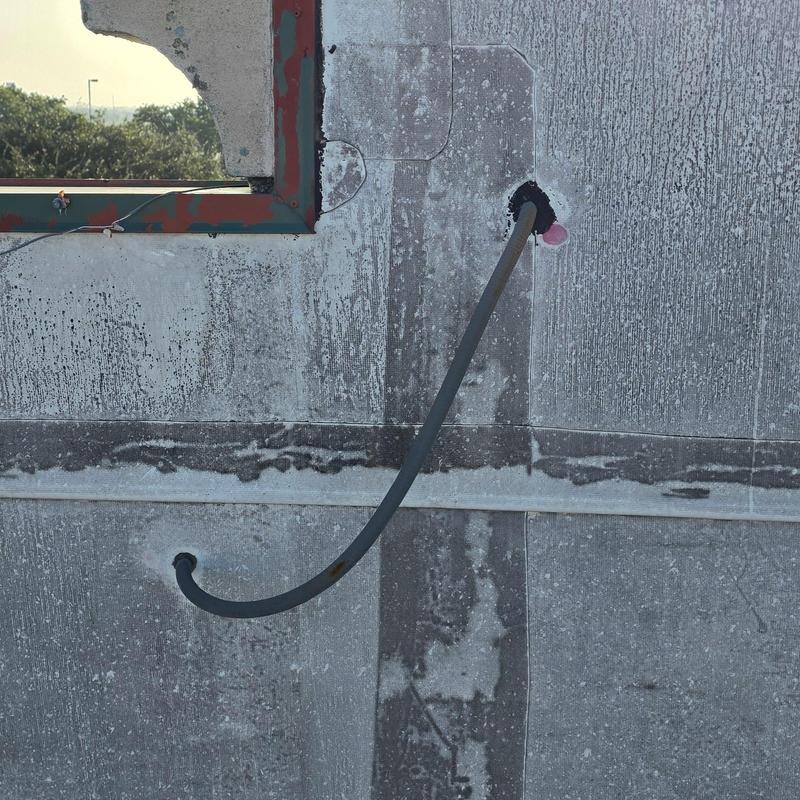 Roof conduit pipe installation on flat roof surface