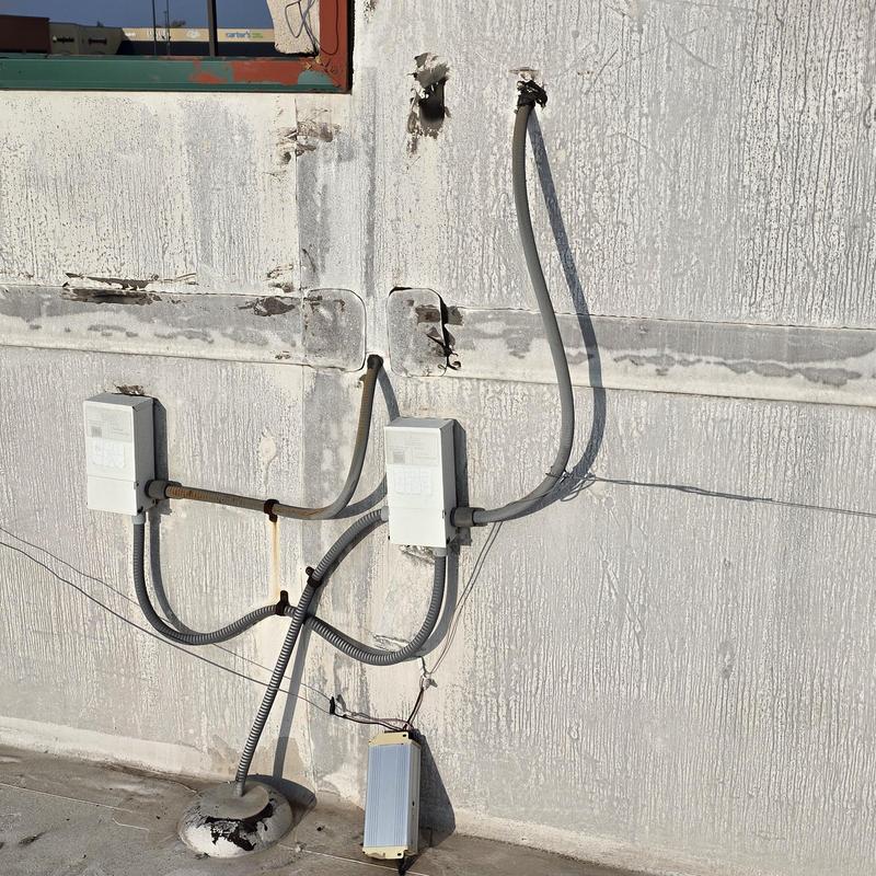 Electrical meter boxes and conduit on exterior wall