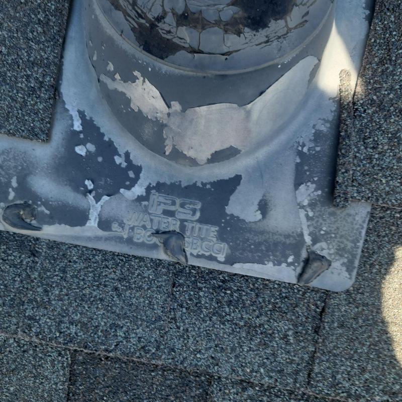 Pipe jack flashing with weathered sealant on shingle roof Pipe jack flashing with weathered sealant on shingle roof