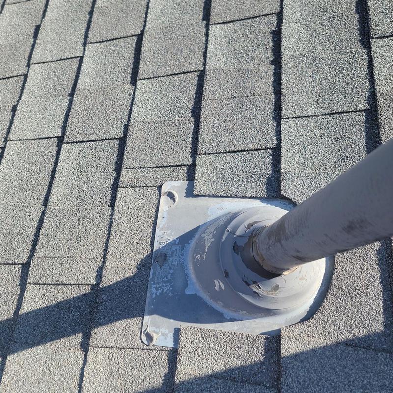 Pipe jack sealing on shingle roof close-up Pipe jack sealing on shingle roof close-up